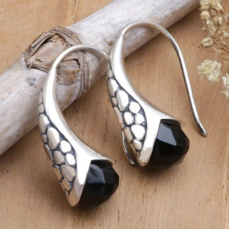 Stylish vintage teardrop earrings with black stone – creative carved metal jewelry for elegant looks.
